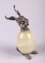 An onyx and white coloured metal paperweight in the form of a rabbit, 10cms high.