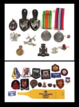 A small quantity of WWII militaria to include Defence medal, badges, cap badges, lapel badges,