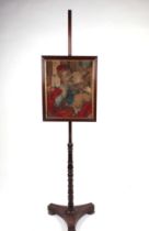 A 19th century rosewood pole screen, the tapestry panel depicting a priest and child, on a turned