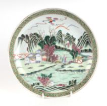 A Chinese famille vert shallow bowl decorated with figures in a landscape, 26cms diameter. Condition