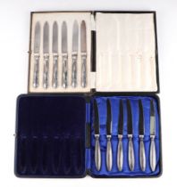 A set of six silver handled tea knives, cased; together with a similar set (2).