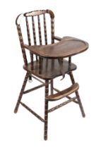 An early 20th century child's stained beech high chair on bobbin turned supports.