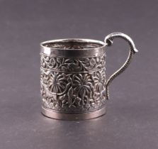 An Indian silver coloured metal tankard decorated with animals amongst foliage, 7cms high, 114g.