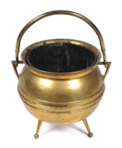 An Arts & Crafts brass cauldron shaped tripod coal bucket by William Soutter & Sons Co., 35cms