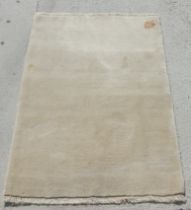A beige Persian Gabbeh rug, 150 by 100cms.