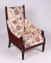 An Edwardian walnut framed upholstered armchair.