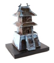 A Chinese mottled blue glaze Shiwan house, mounted on an ebonized wooden stand, 33cm high
