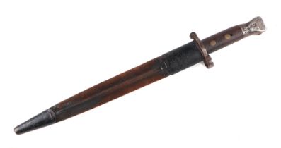 A WWI bayonet with 30cms steel blade, signed 'Wilkinson London', with metal and leather scabbard.