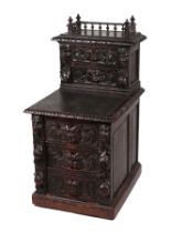 A Victorian carved oak bedside cabinet, the galleried superstructure with two drawers above three