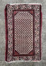 A Caucasian prayer rug, having a central floral repeating motif within a multi border, 115cm by