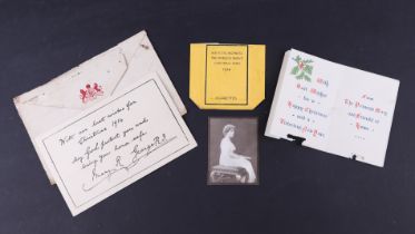A WWI Queen Mary Christmas card, an empty Queen Mary tin cigarette packet and George V and Queen