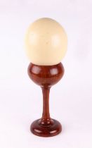 Taxidermy - An ostrich egg on a turned wooden stand. Condition Report General good condition.