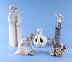 A group of Lladro figures to include nuns, small girls and a swan, the largest 32cms high (5).