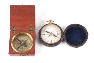 A 19th century gilt brass pocket compass in a leather case, 5cms diameter; together with a