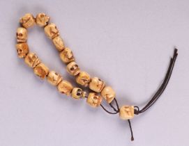 A Tibetan carved bone skull bead necklace.