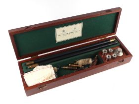 A gun cleaning kit for 12 and 20 bore shotguns, the lid bears Holland & Holland label, in a mahogany