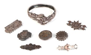 A collection of Victorian silver brooches; together with a similar silver bangle, 42g. Condition
