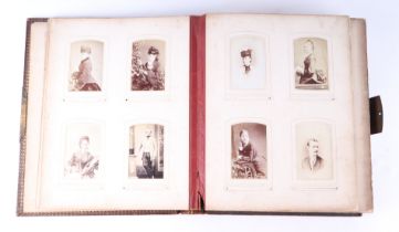 A Victorian tooled leather album of carte de visites and cabinet photographs, the majority portraits