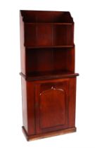 A 19th century mahogany open bookcase on cupboard, the upper section with two-tier bookcase on
