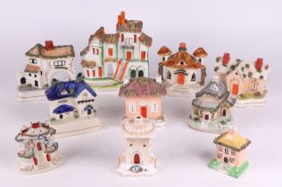 A group of Staffordshire cottage pastille burners and similar houses, largest 21cm high (10)