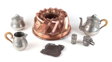 A Victorian copper jelly mould, 24cms diameter; together with a Liberty & Co. part pewter cruet