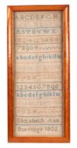 A Victorian sampler by Elizabeth Ann Burridge 1862, with alphabet and verse, 18 by 44cms, framed &