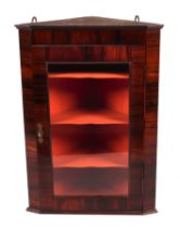 A rosewood corner cupboard, the single glazed door enclosing a shelved interior, 51cms wide.