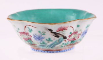 A Chinese Qing dynasty famille rose lotus flower bowl decorated with birds and flowers, red seal