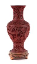 A Chinese cinnabar lacquer vase on stand, 26cms high.