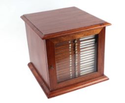A late 19th/early 20th Century mahogany microscope slide cabinet, the single glazed door enclosing
