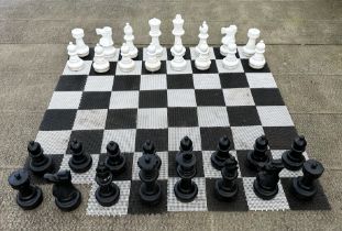 A contemporary plastic oversized garden or public park chess set, king 64cms high.