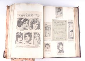 A gentleman's late Victorian scrap book containing postcards, heraldic ephemera, drawings, prints