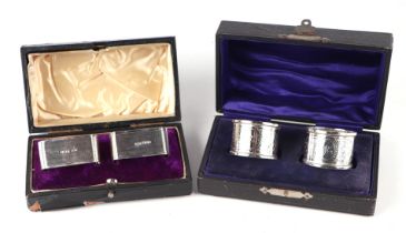 A cased pair of Victorian silver napkin rings with engraved decoration, initialled 'LE', Sheffield