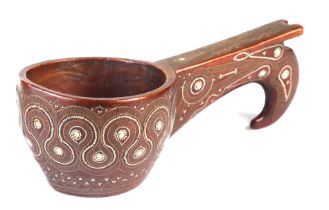 A Russian carved hardwood kovsh with white metal inlay decoration, 19cms long.