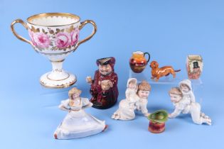 A Cauldon twin handled pedestal cup decorated roses, 17.5cm high; a Royal Doulton character mug,