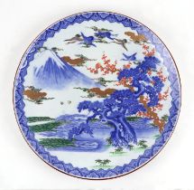 A large Japanese charger decorated with a mountainous landscape scene, 46cms diameter.