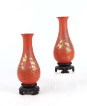 A pair of Chinese Foo Chow style Tai Kut lacquer vases decorated a gilded landscape scene on a red