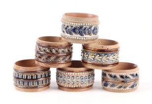 A set of six Doulton Stoneware napkin ring (6). Condition Report One has been broken and re-glued.