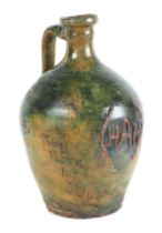 A 19th century style slipware pottery jug with applied initials 'HAH', and painted motto 'Thomas