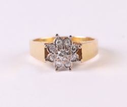 An 18ct gold and diamond flower head cluster ring, approx UK size 'N', 4.9g.