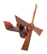A scratch built wooden windmill weather vane, 63cms long.