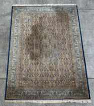 A Keshan rug with repeated geometric design on a beige ground. 250 by 344cm