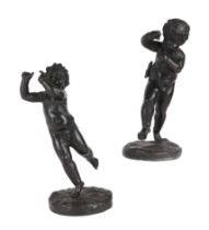 A pair of Regency bronze Amorini on bases, 21cms high (2).