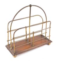 An Edwardian brass and oak two-division magazine rack, 36cms wide.