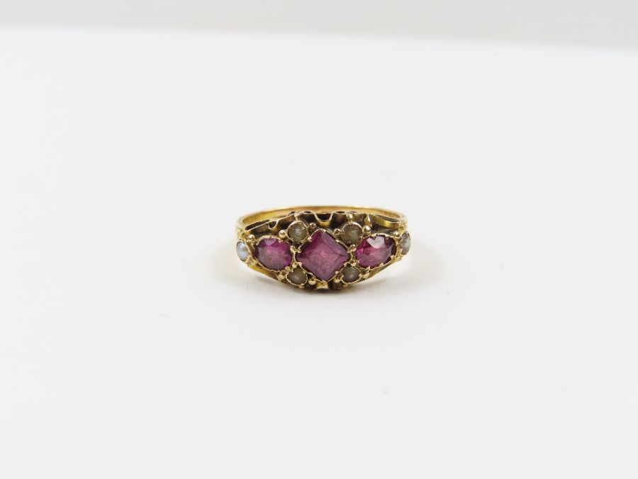 A Victorian 15 carat gold garnet and seed pearl ri