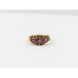 A Victorian 15 carat gold garnet and seed pearl ri