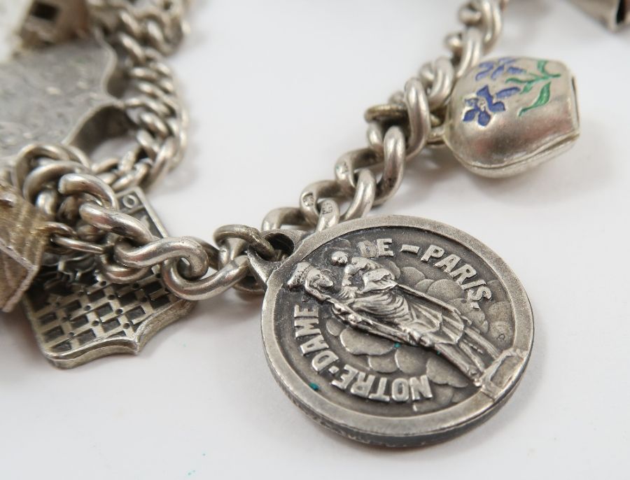 A silver curb link bracelet, with various charms a - Image 3 of 10