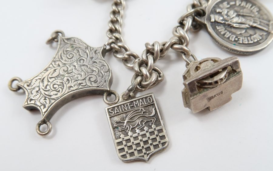 A silver curb link bracelet, with various charms a - Image 4 of 10