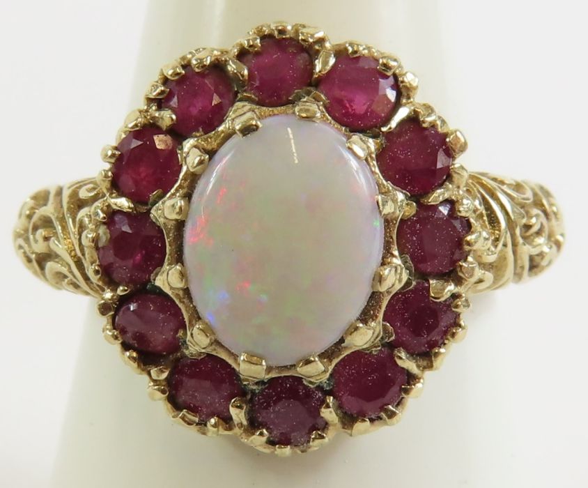 A 9ct gold opal and ruby cluster ring, the oval op - Image 9 of 9