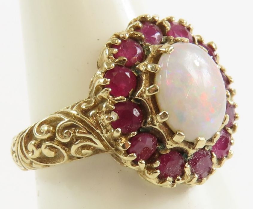 A 9ct gold opal and ruby cluster ring, the oval op - Image 8 of 9